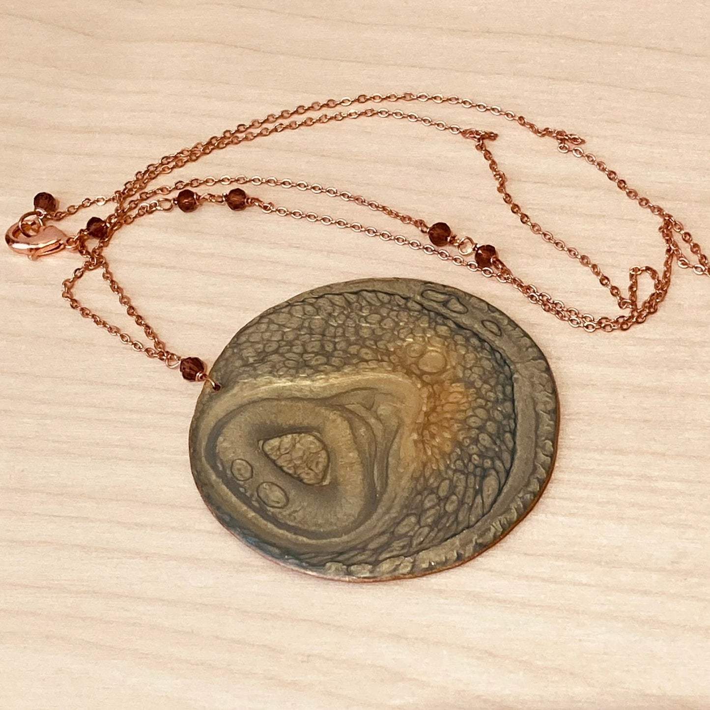 Copper necklace with square pendant, embellished with amethyst pearl.