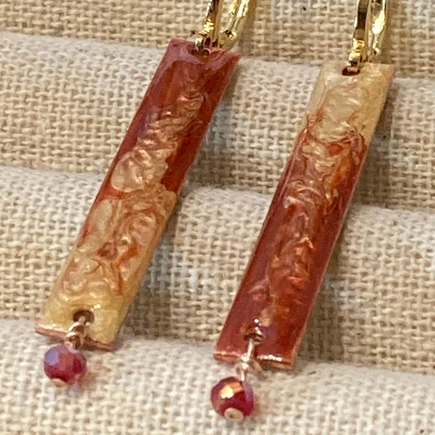 Rectangular red-gold copper earrings, embellished with a small crystal.