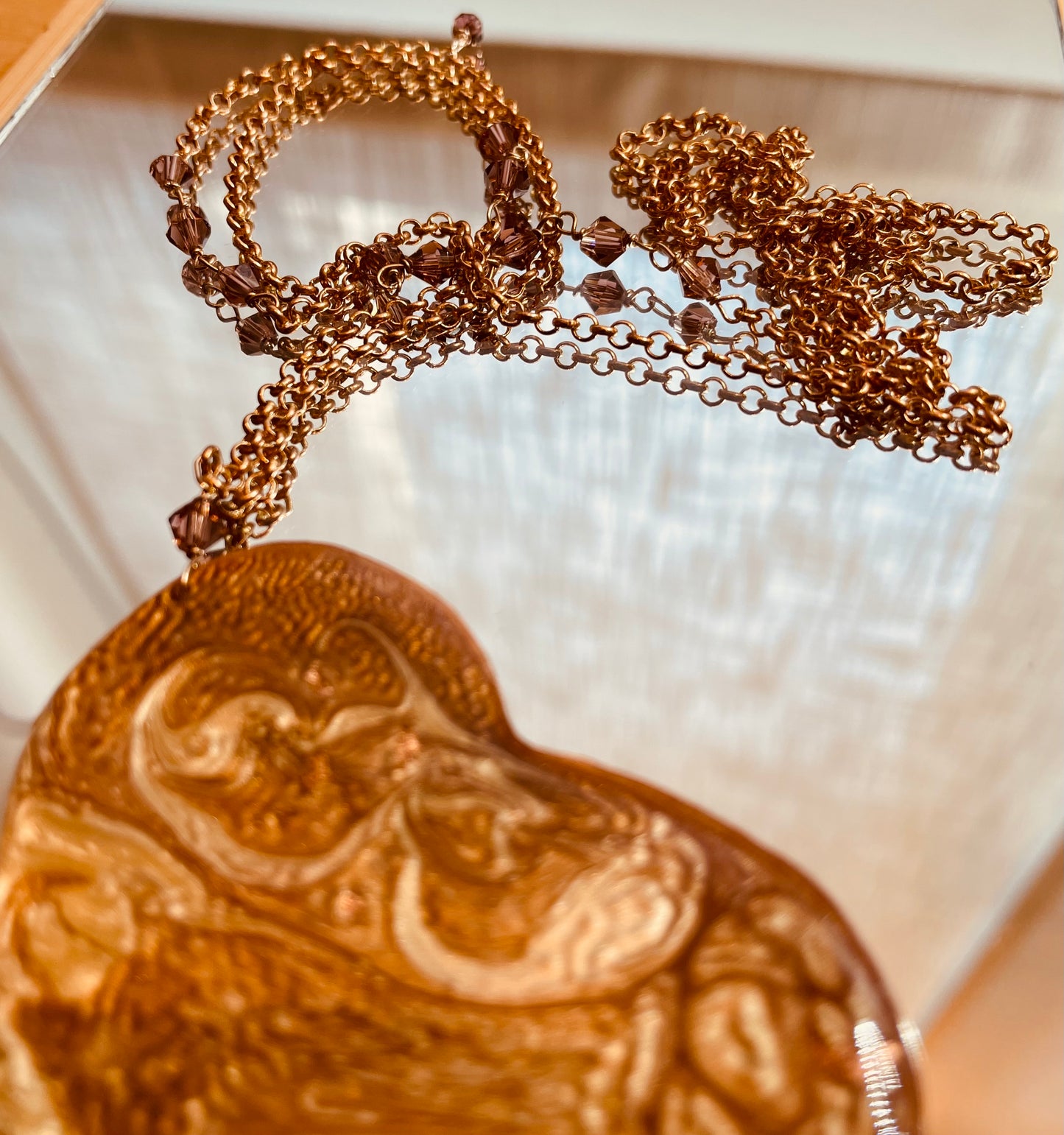 Copper necklace with square pendant, embellished with amethyst pearl.