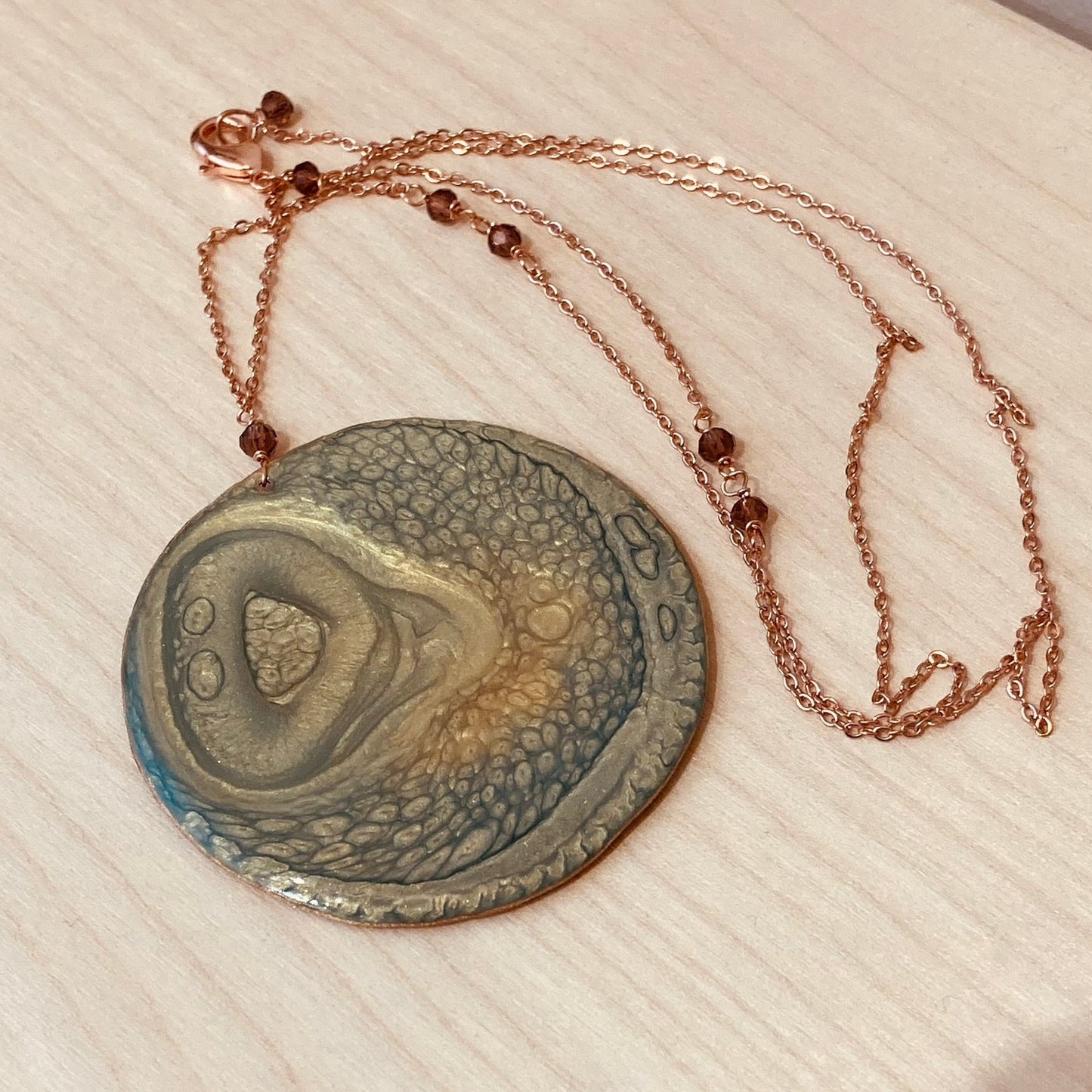 Copper necklace with square pendant, embellished with amethyst pearl.