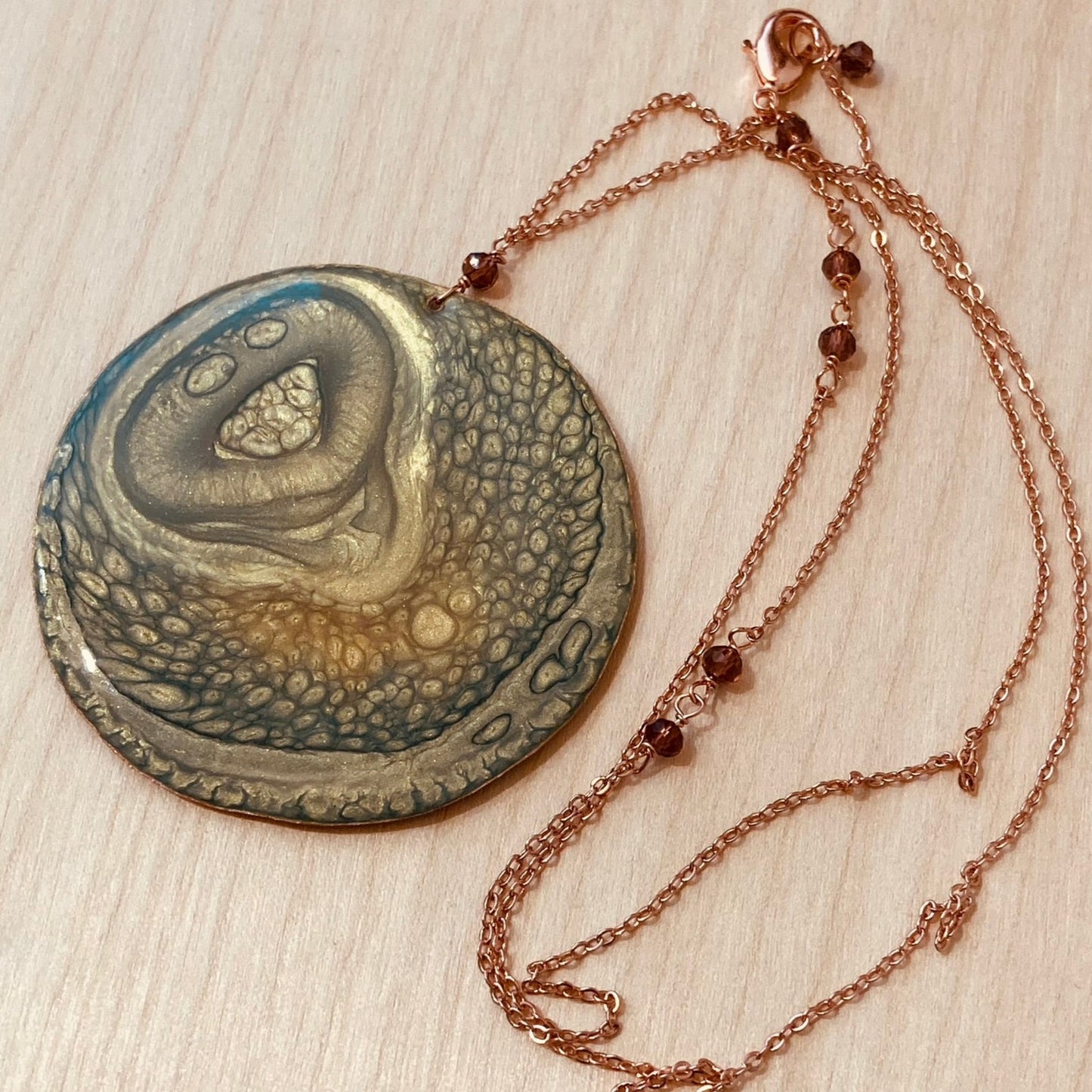 Copper necklace with square pendant, embellished with amethyst pearl.