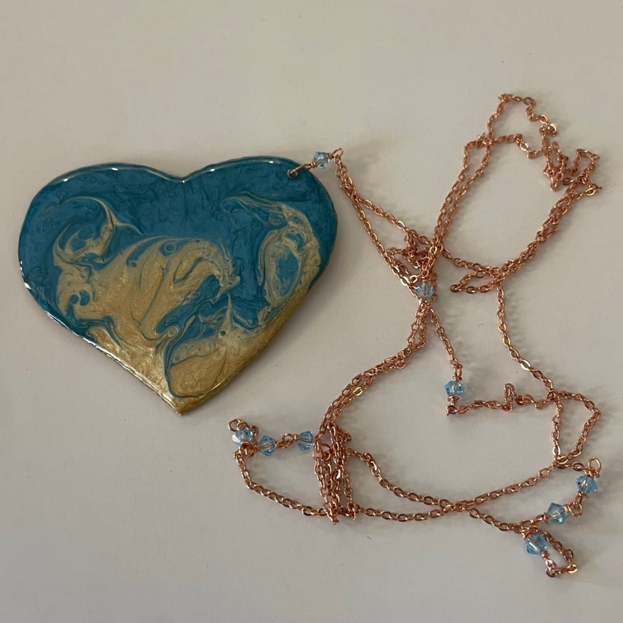 Copper necklace with square pendant, embellished with amethyst pearl.