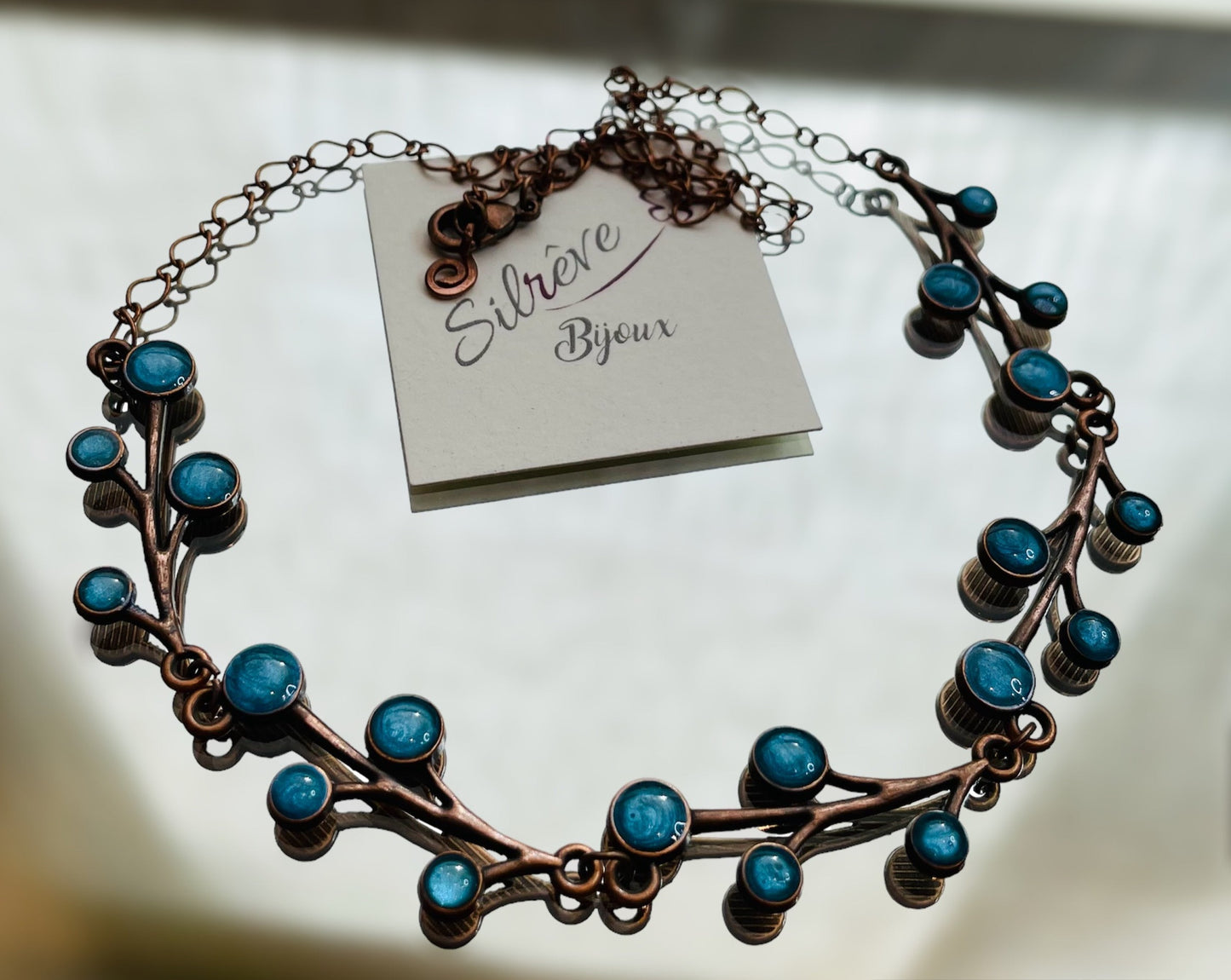 Red copper necklace with floral motifs