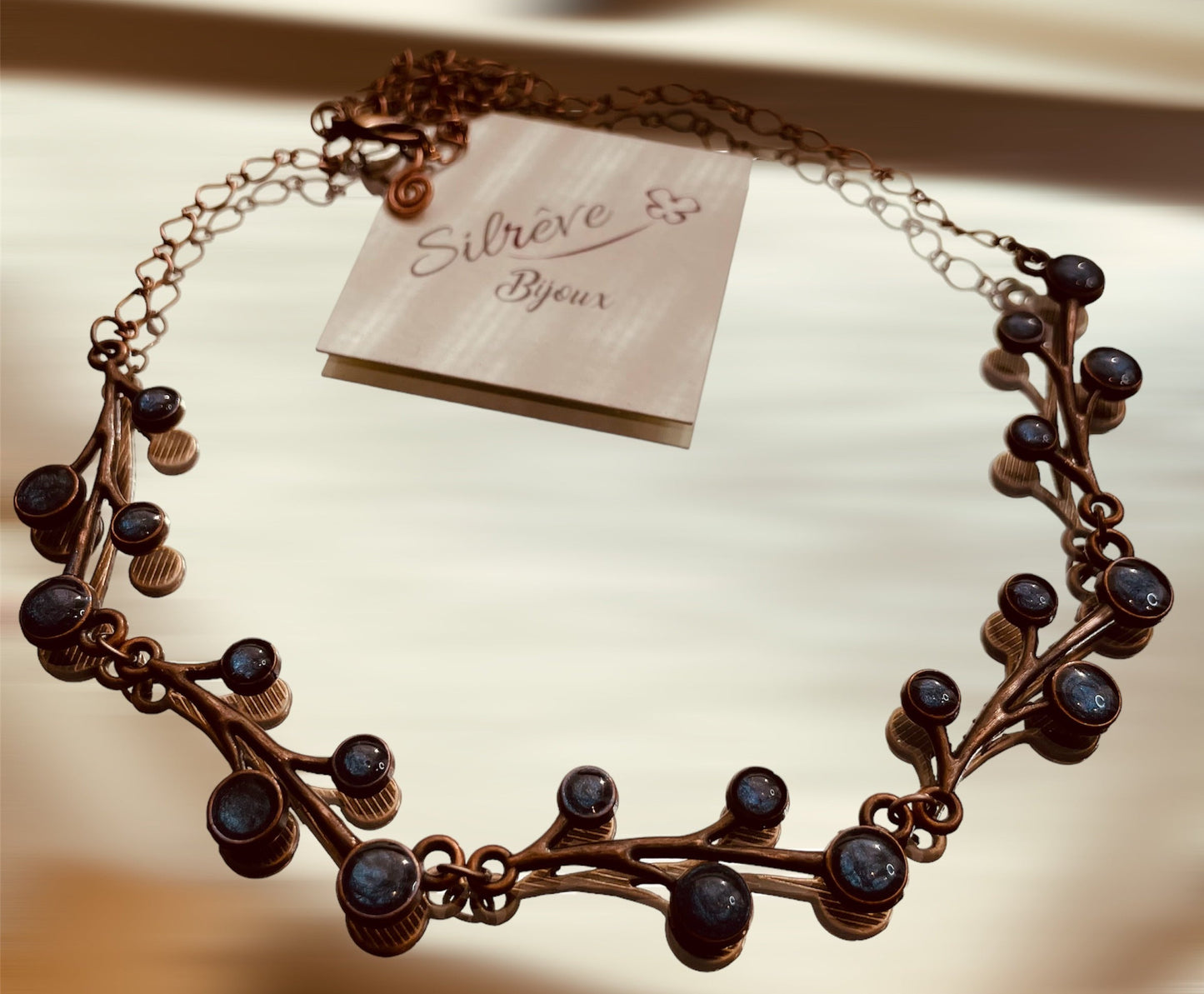 Red copper necklace with floral motifs