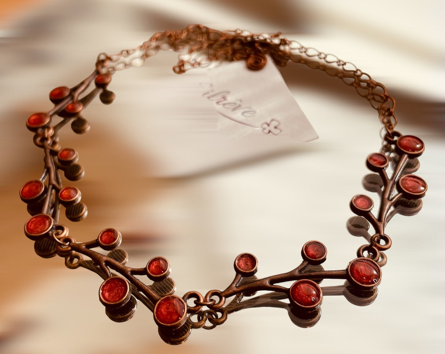 Red copper necklace with floral motifs