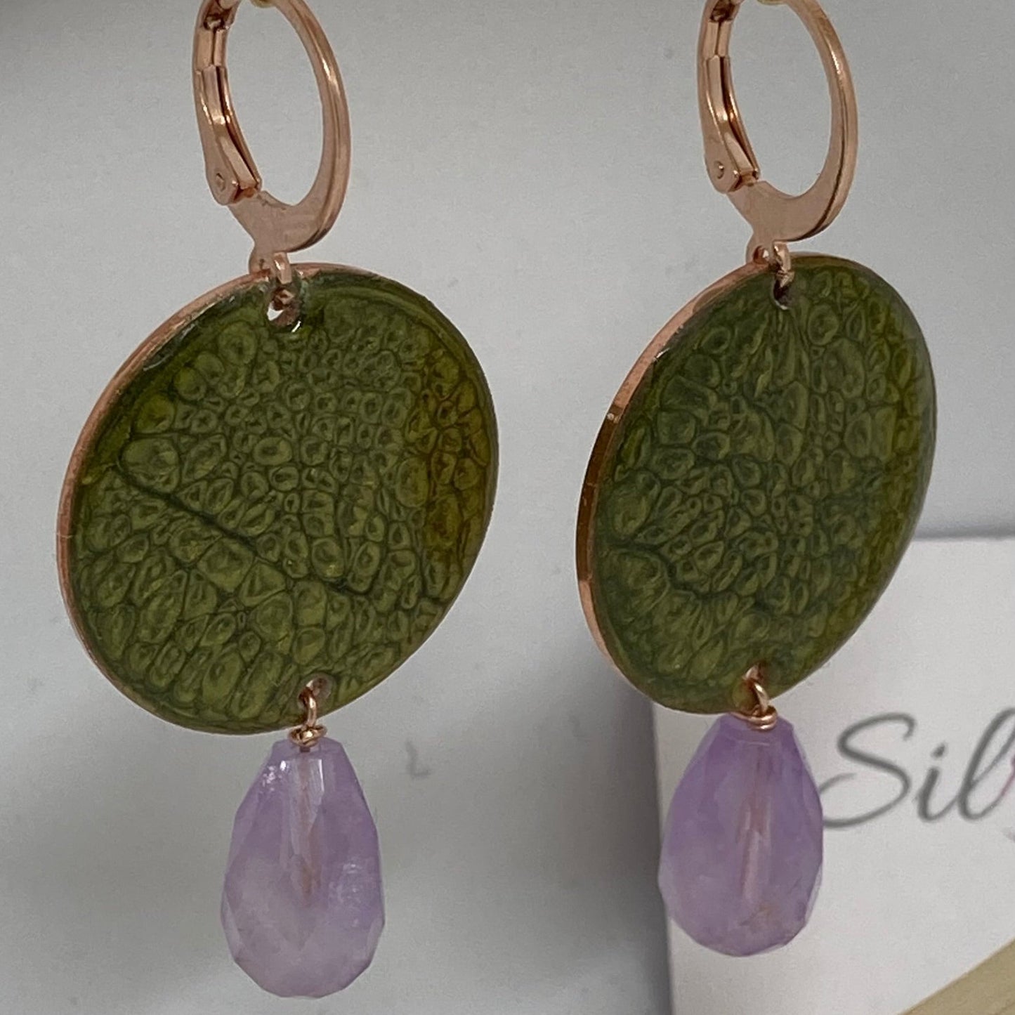 Copper pendant earrings embellished with amethyst drops.