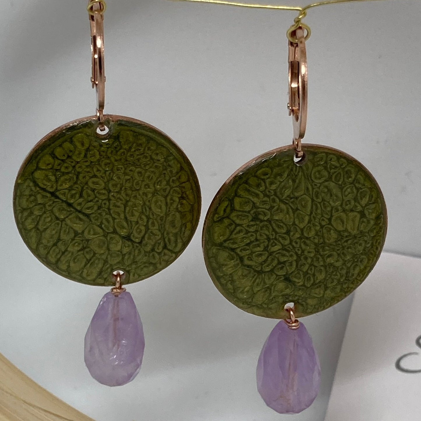 Copper pendant earrings embellished with amethyst drops.
