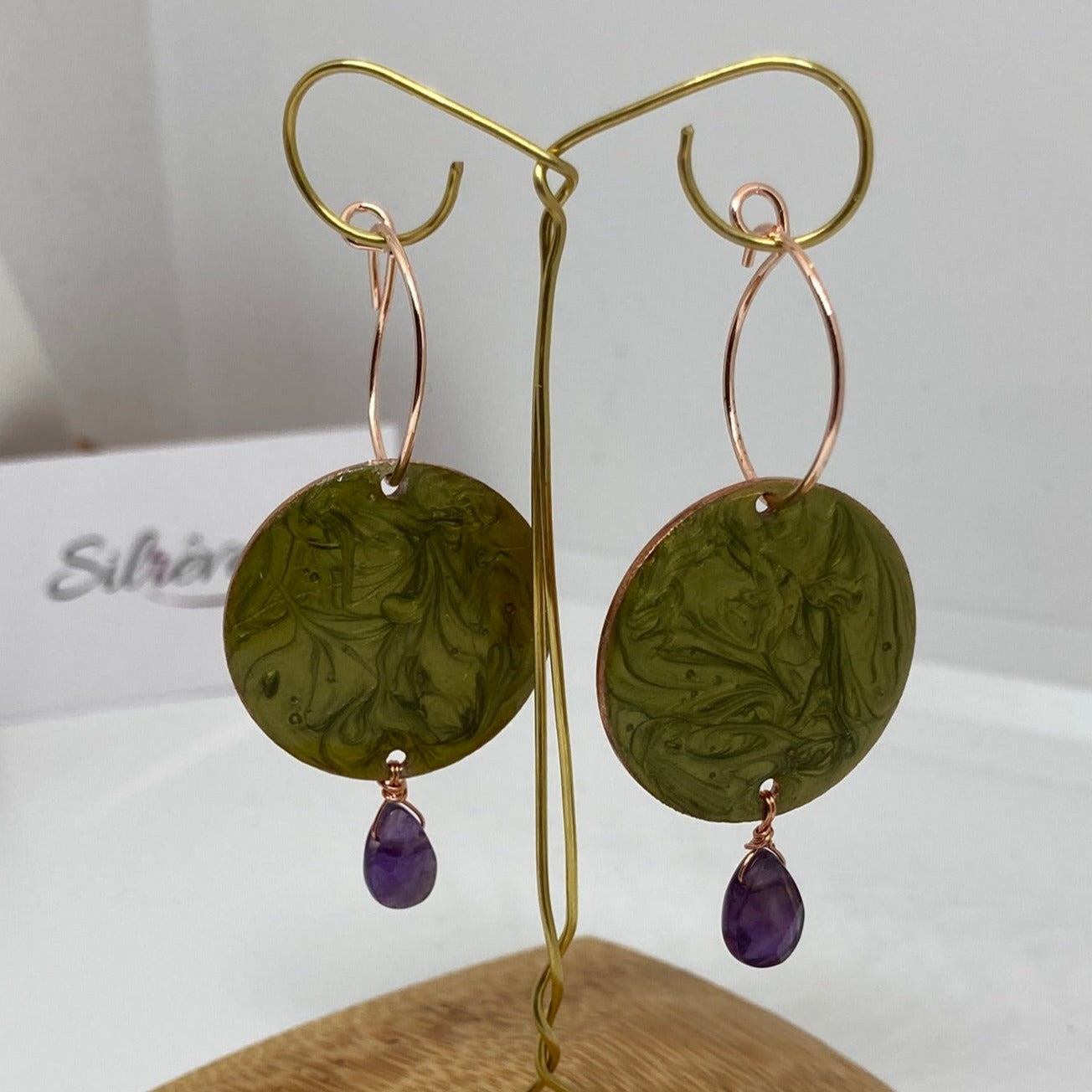Copper pendant earrings embellished with amethyst drops.
