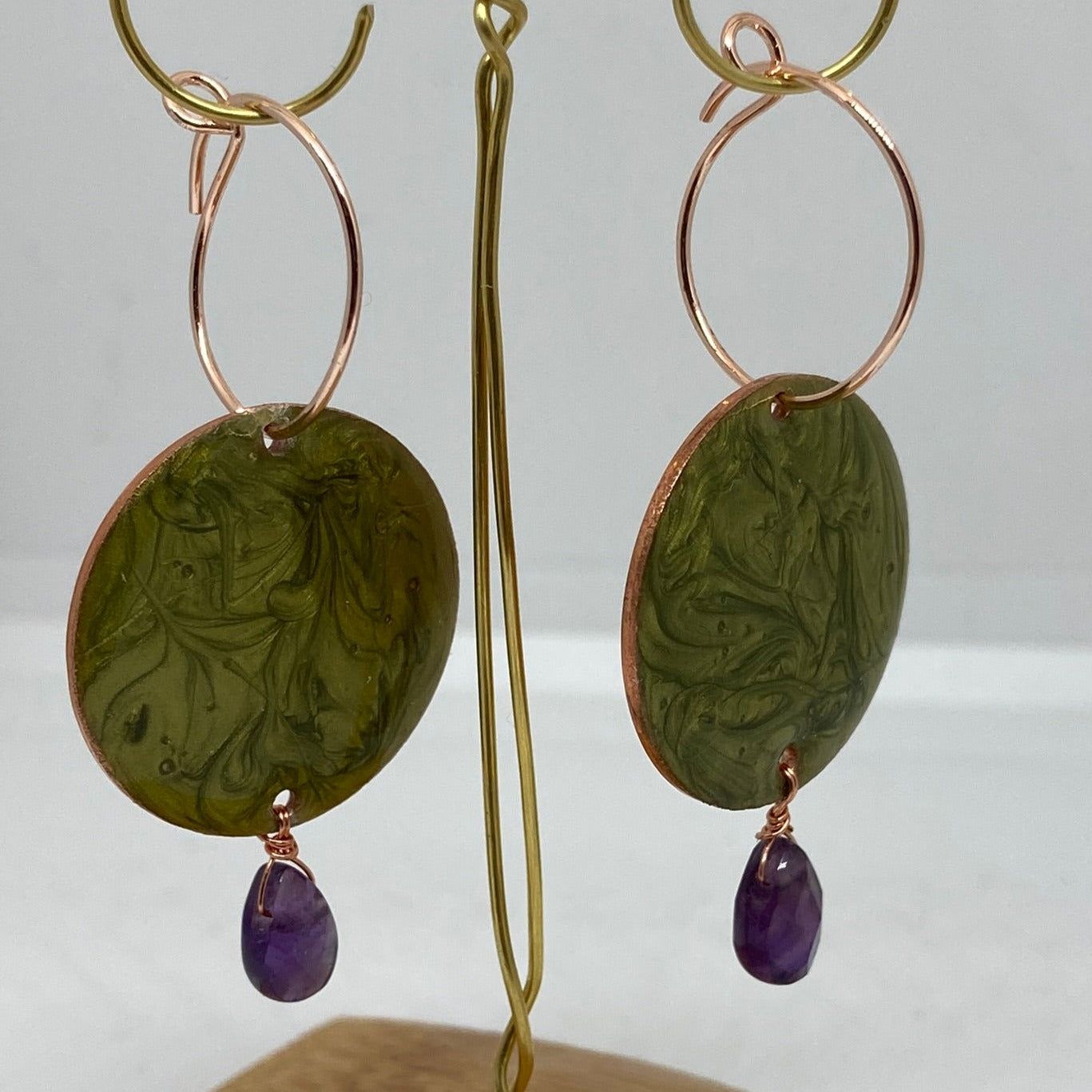 Copper pendant earrings embellished with amethyst drops.