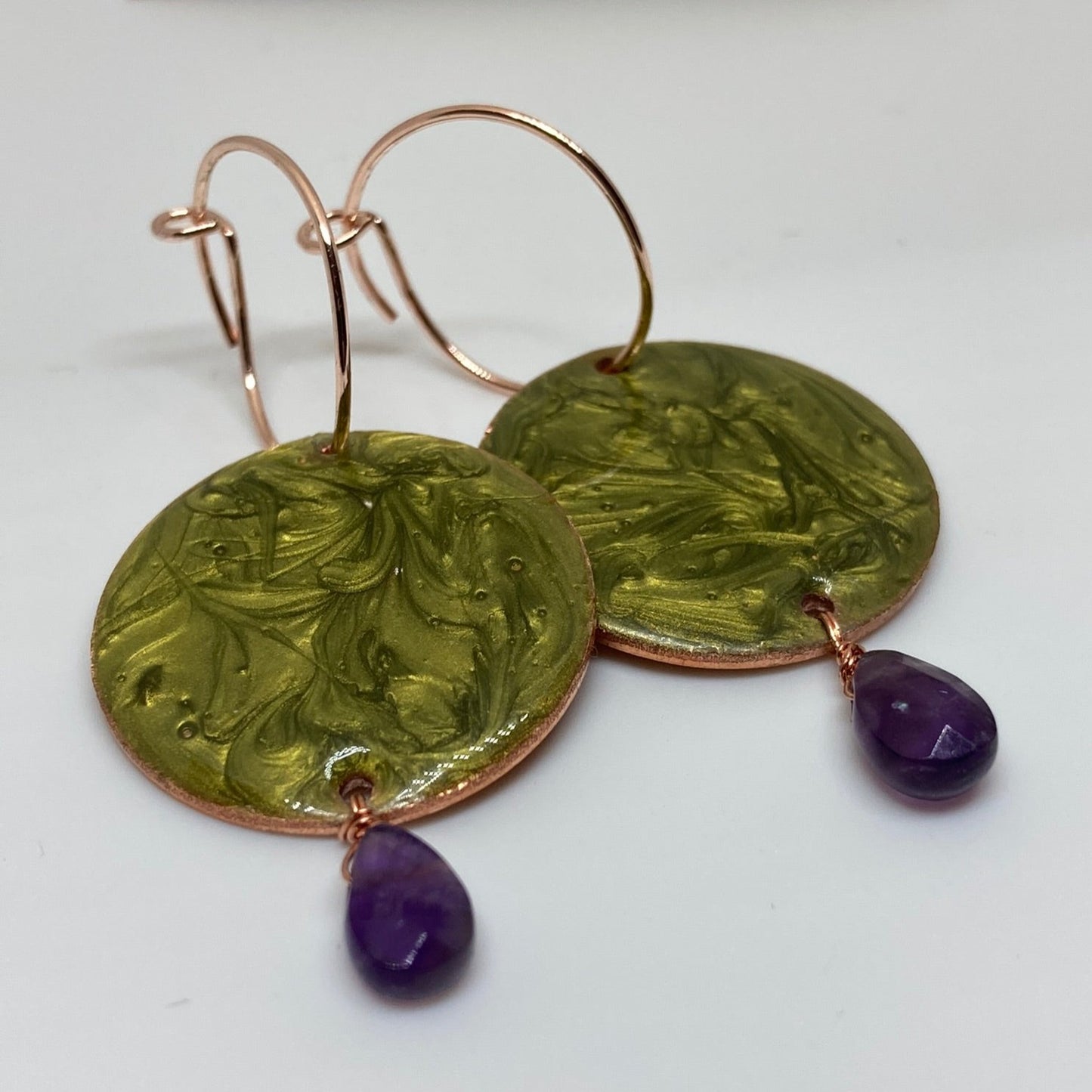 Copper pendant earrings embellished with amethyst drops.