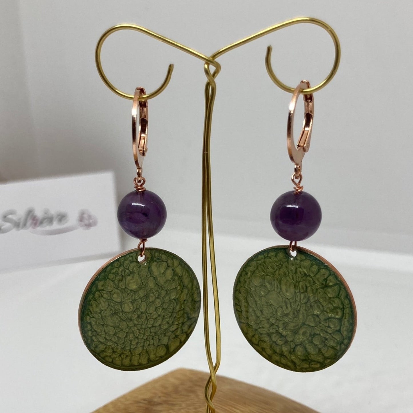 Copper pendant earrings embellished with amethyst beads.