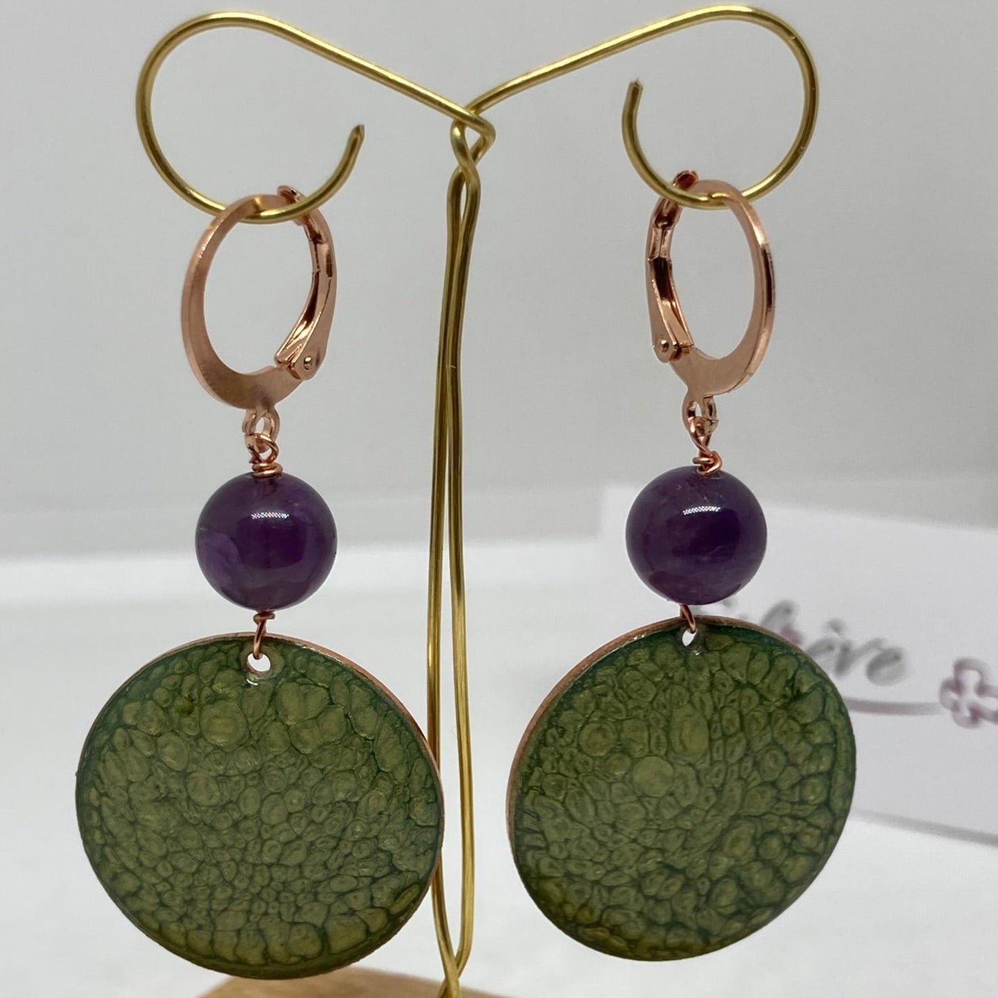 Copper pendant earrings embellished with amethyst beads.
