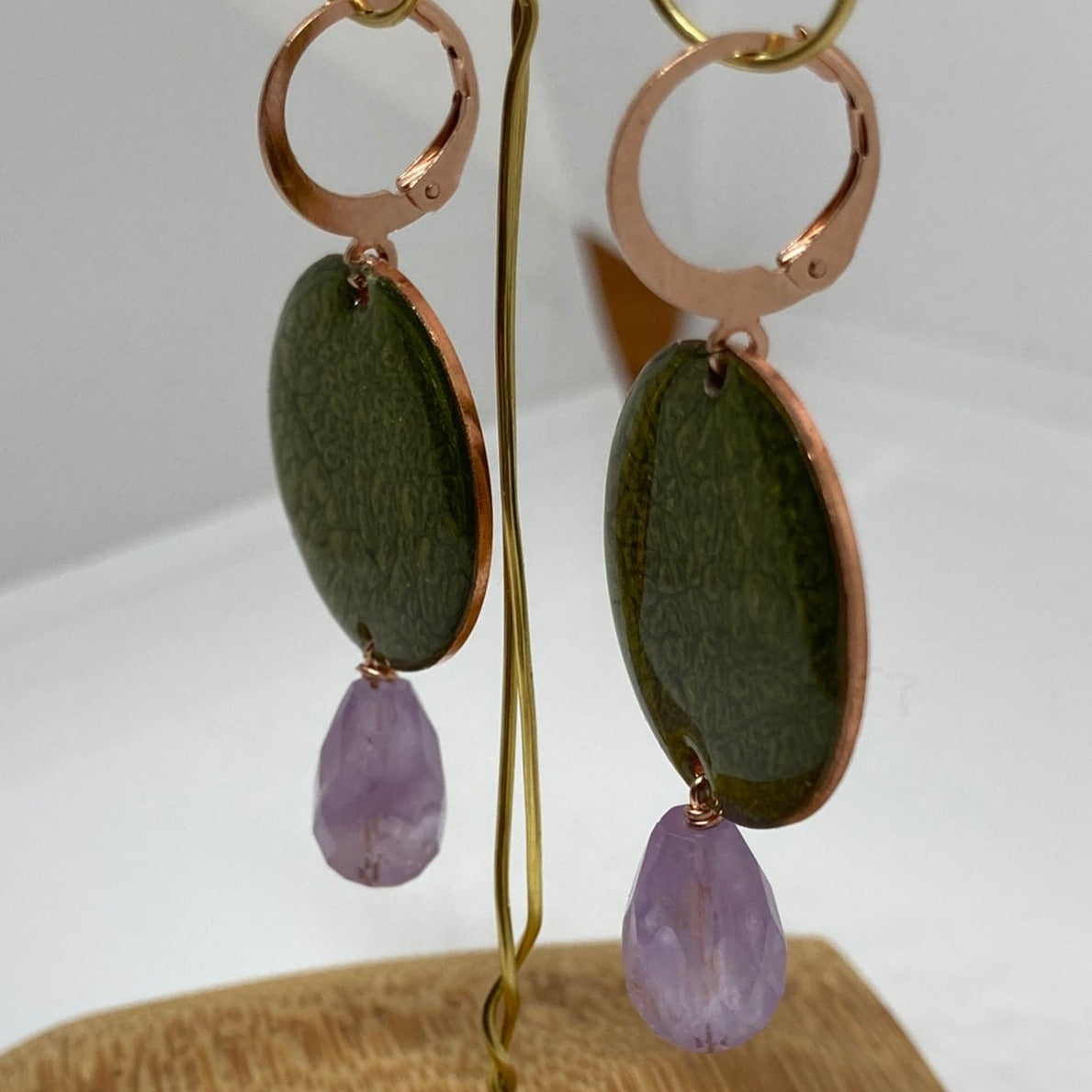 Copper pendant earrings embellished with amethyst drops.