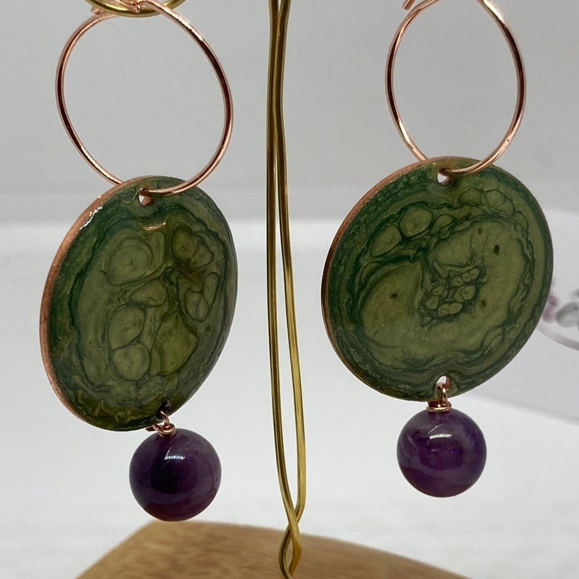 Copper pendant earrings embellished with amethyst beads.
