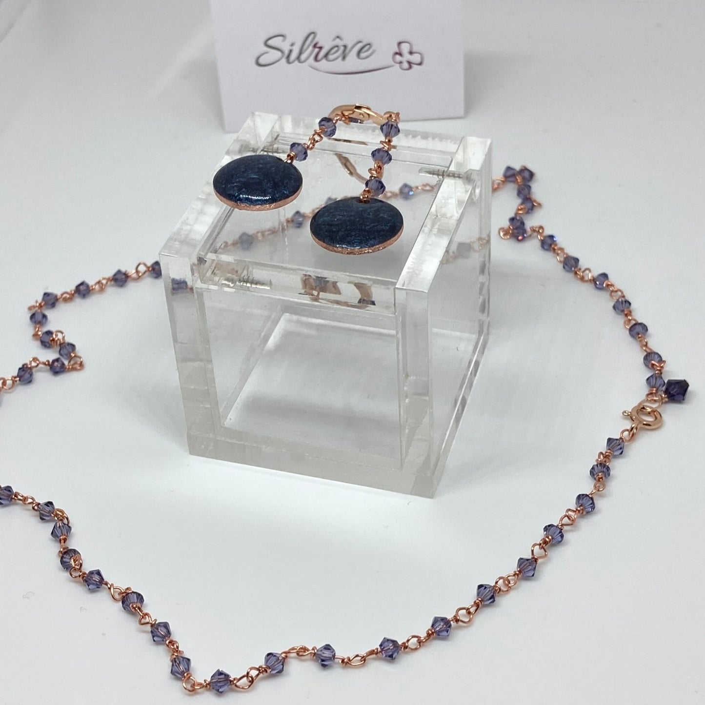 Copper pendant earrings embellished with small crystals.