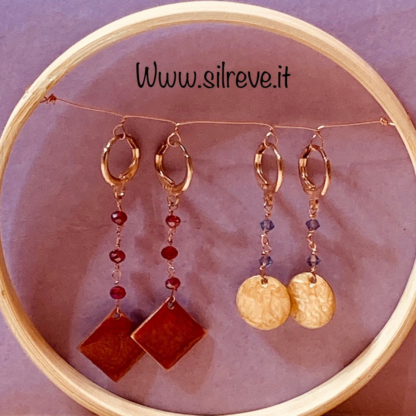 Copper pendant earrings embellished with small crystals.