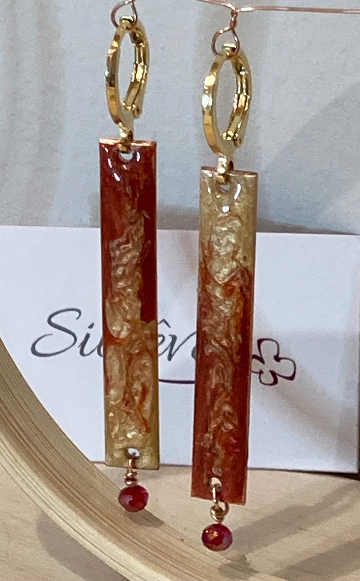 Rectangular red-gold copper earrings, embellished with a small crystal.