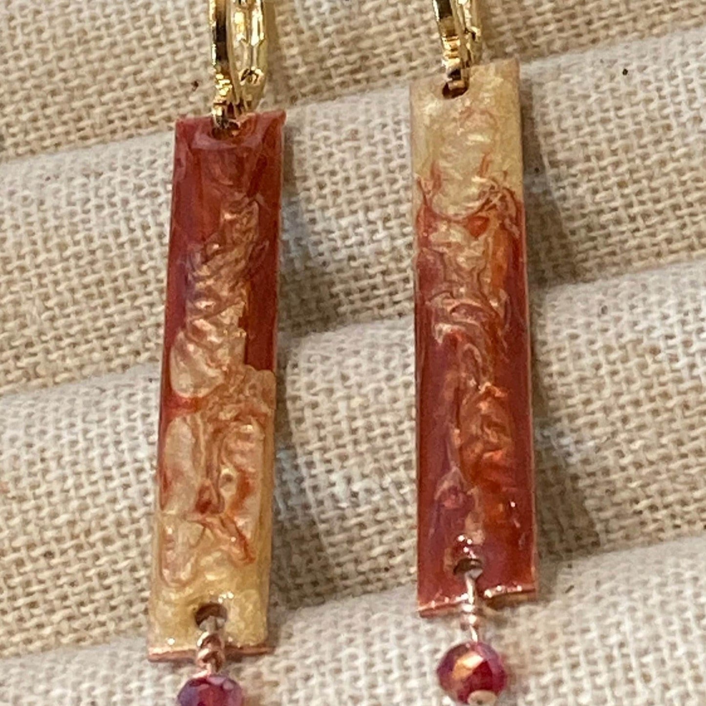 Rectangular red-gold copper earrings, embellished with a small crystal.