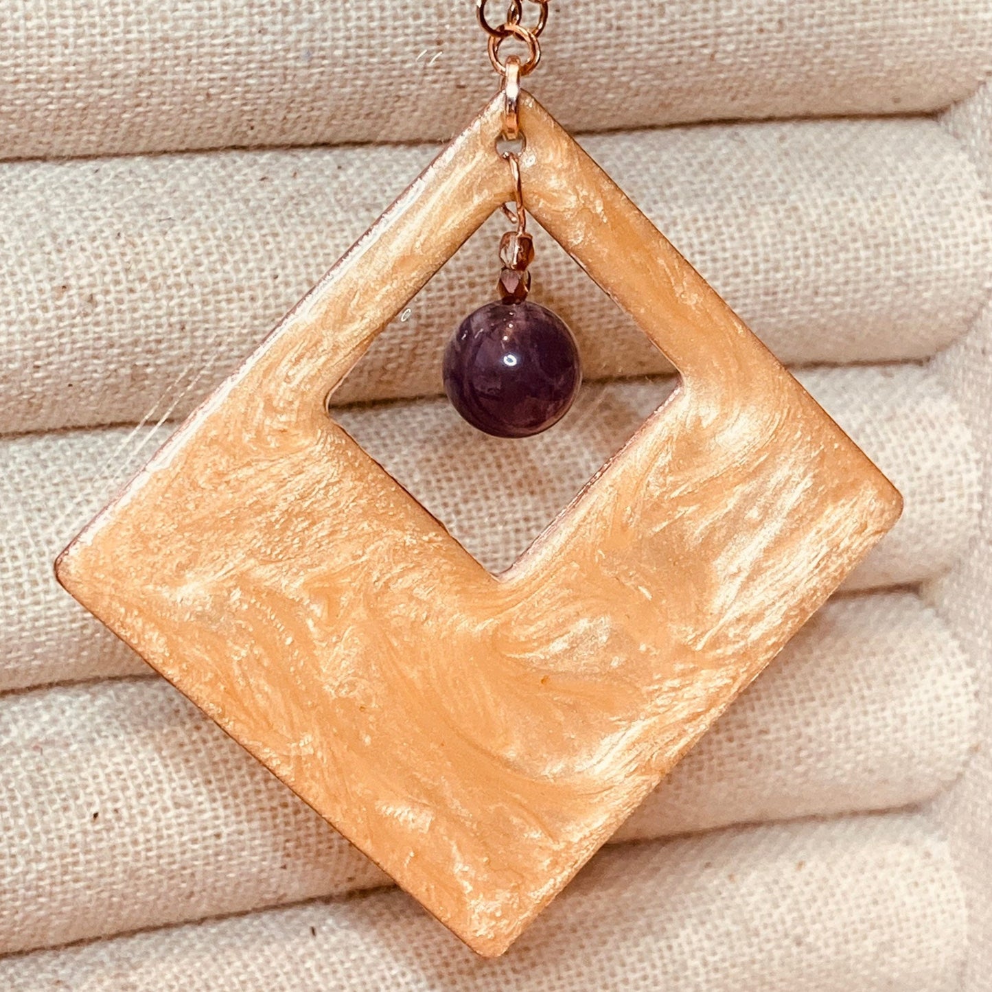 Copper necklace with square pendant, embellished with amethyst pearl.
