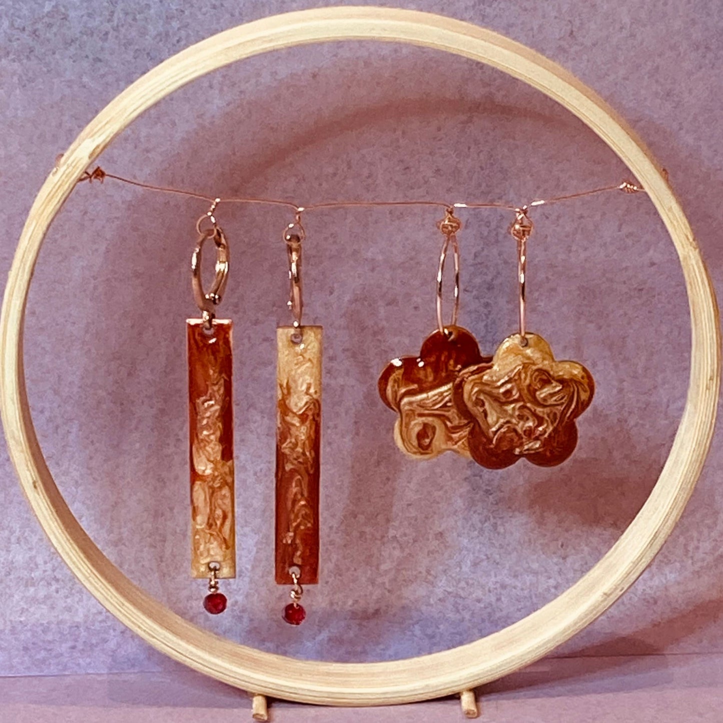 Rectangular red-gold copper earrings, embellished with a small crystal.