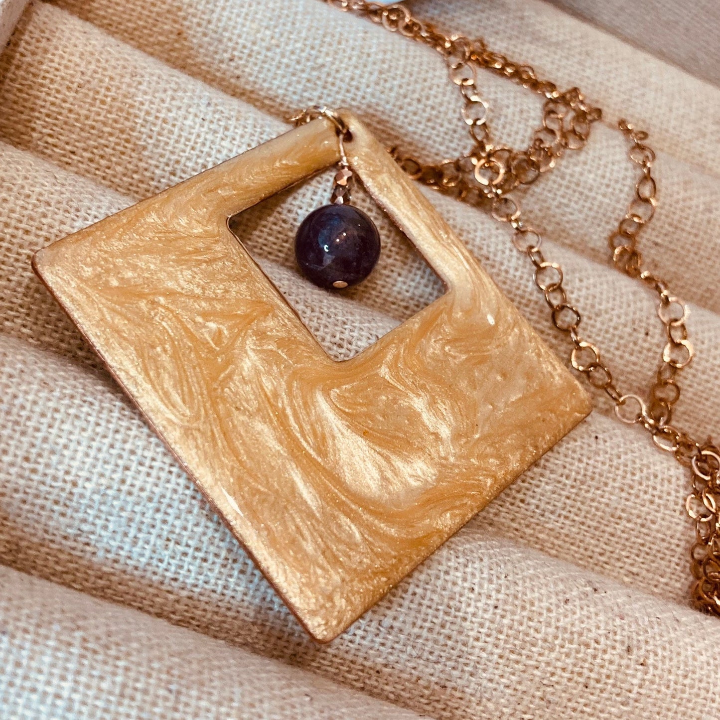 Copper necklace with square pendant, embellished with amethyst pearl.